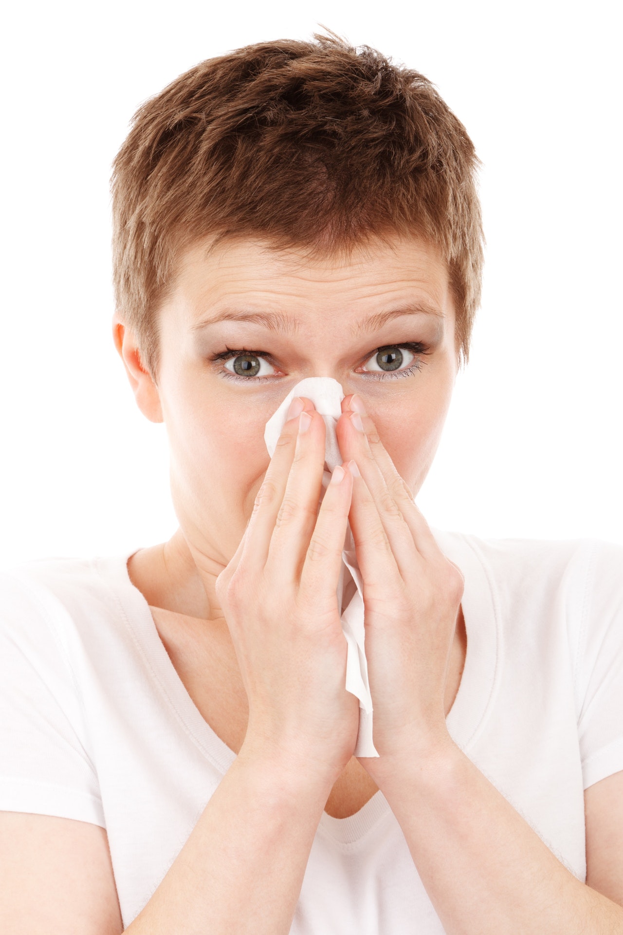 woman blowing her nose, sick due to flu