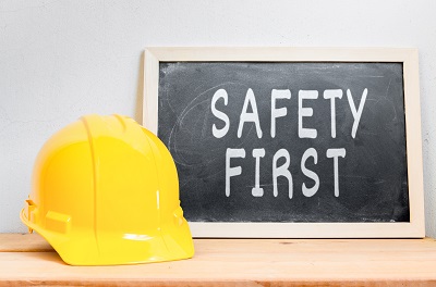 image of hard hat and a safety first sign